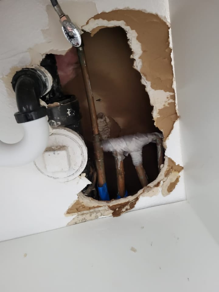 EMS crew documenting moisture damage in the hall bath, Riverside, CA.