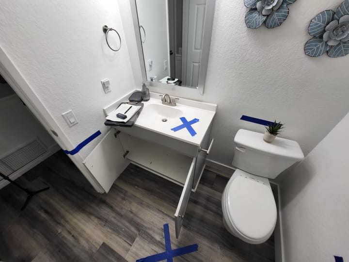EMS crew documenting moisture damage in the hall bath, Riverside, CA.